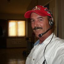 Patrick Cannon wearing a baseball cap and a communication headset.