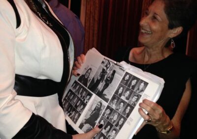 40th reunion at Maggiano's, Cori Drasin and Sandy Brenner looking at a picture of Cori Drasin and Sandy Brenner in the 1974 yearbook.