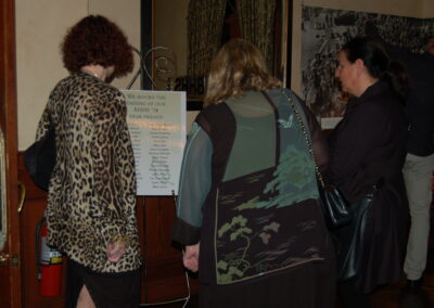 40th reunion at Maggiano's, pictured are May Quigley Goodman, Wendy Levin and Kim Bryan looking at the sign honoring fellow classmates that have passed away.