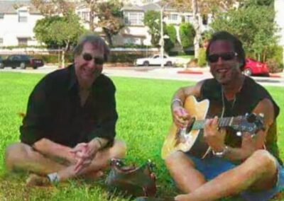 40th reunion picnic on the BHHS front lawn, David Freshman and Barry Chase. Barry is playing a guitar.